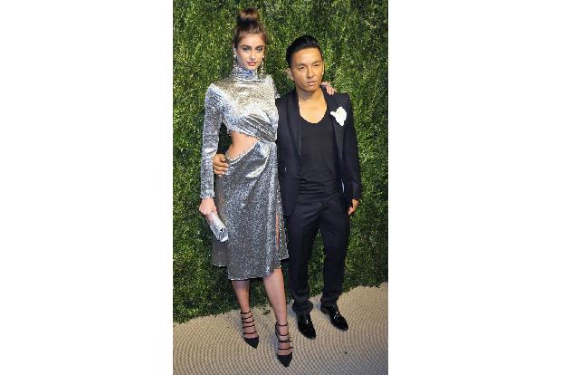 ...Model Taylor Hill und Prabal Gurung. Der kreierte ein silber-glänzendes Teil mit Aussparungen an der Hüfte, das obenrum m...