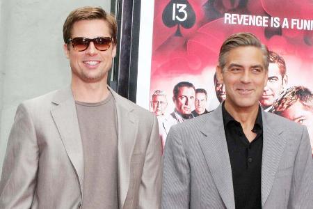 Brad Pitt (l.) und George Clooney spielten in allen drei Teilen der 