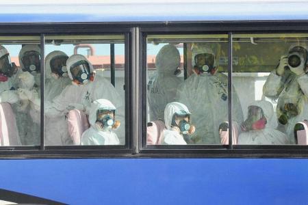 TOKYO, Japan - A reporter takes photographs from inside a bu...