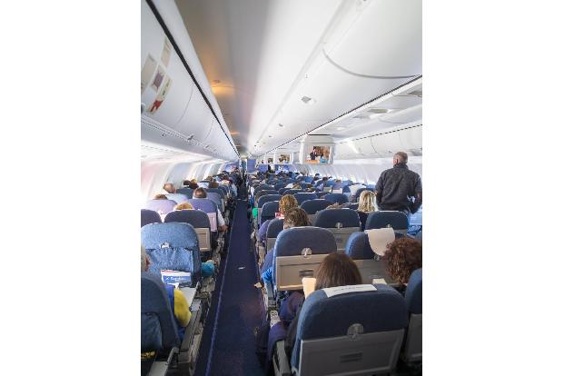 Cabin of aircraft Boing 767 with passengers PUBLICATIONxINxG...