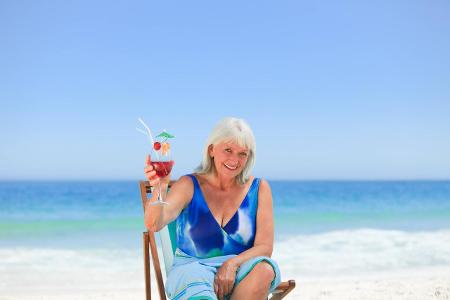 Elderly woman drinking a cocktail Elderly woman drinking a c...