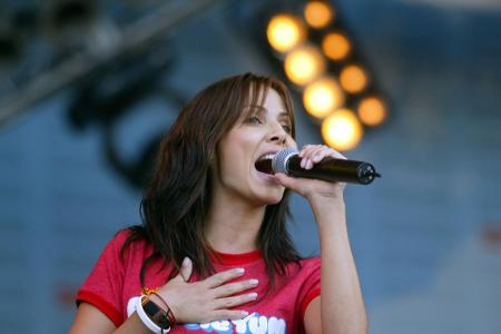 In welcher Hand hält hier Sängerin Natalie Imbruglia ihr Mikrofon?