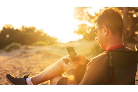 Camper Man using smart phone and holding credit card while shopping