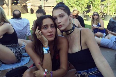 Bei einer Tanzpause im Schatten trägt Bella Hadid ein schwarzes Top mit Spaghetti-Trägern und angesagte High-Waist-Jeans.
