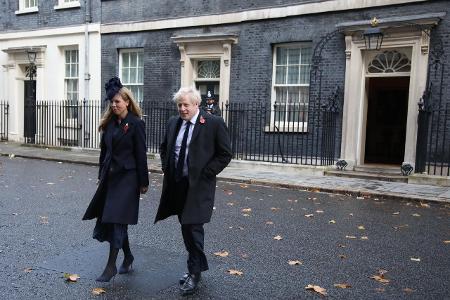 Prime Minister Boris Johnson and partner Carrie Symonds lea...