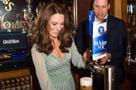 Herzogin Kate zapft unter den Augen ihres Ehemannes Prinz William ein Bier