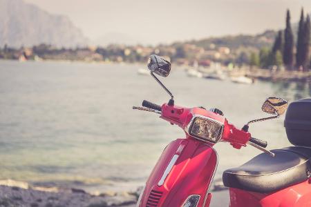 Beautiful red scooter on the beach, landscape and blue sky L...