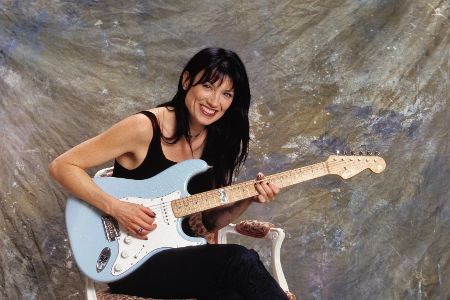 Frau mit Gitarre auf dem Schoß