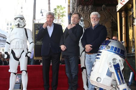 Hier sehen wir den Regisseur mit Harrison Ford, R2D2 und Mark Hamill bei dessen Zeremonie für seinen Stern auf dem Hollywood Walk of Fame. Kein Zweifel: George Lucas wird für immer der Vater von 'Star Wars' bleiben.