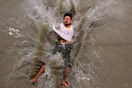 Kühlen Kopf bewahren während der Hitzewelle: Ein Mann springt in einen Bach in Peschawar. In Pakistan herrschen teilweise Temperaturen von bis zu 50 Grad.