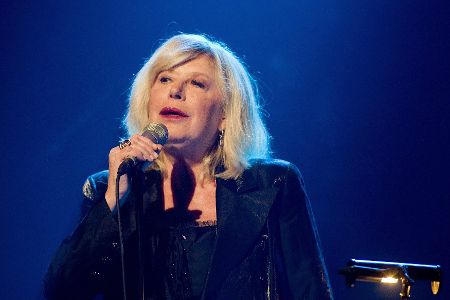 Marianne Faithfull mit Mikrofon in der Hand beim Singen