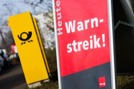 Ein Warnstreik-Schild bei einem Post-Standort, daneben ein Briefkasten - im Ringen um einen Tarifabschluss haben Tausende Postler erneut die Arbeit niedergelegt. Ein Warnstreik-Schild bei einem Post-Standort, daneben ein Briefkasten - im Ringen um einen Tarifabschluss haben Tausende Postler erneut die Arbeit niedergelegt.