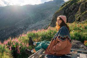 Frau auf Camper-Dach genießt Ausblick