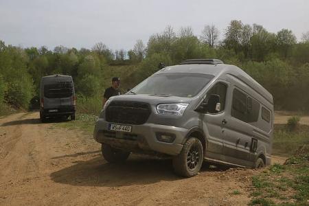 Offroad-Fahrtraining: Staubige Strecke, Campingbus kämpft sich die Steigung hoch