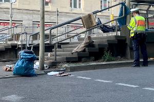 An der Haltestelle liegen Decken, auch ein Kinderwagen ist zu sehen.