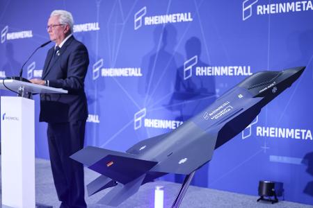 Ein Modell des F-35 auf der Bühne, auf der Konzernchef Papperger zu Mitarbeitern spricht.