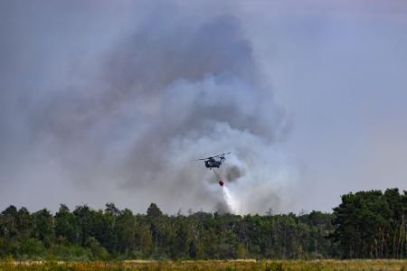 Ein Löschhubschrauber ist beim Waldbrand in der Gohrischheide im Einsatz.