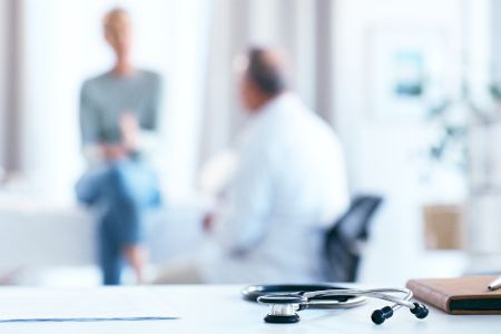 Ein Arzt spricht in einer Praxis mit einem Patienten