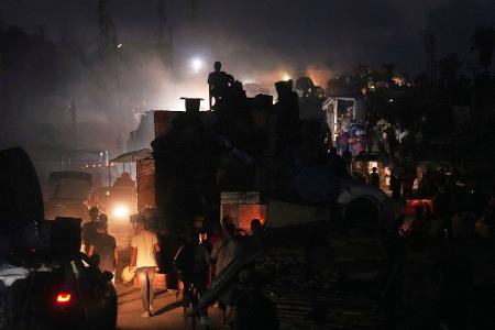 Palästinenser fliehen und tragen ihre Habseligkeiten entlang der Küstenstraße in Richtung des südlichen Gazastreifens.