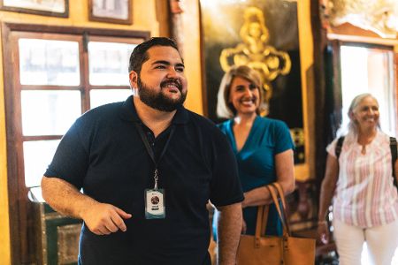 Museumsführer in einem Museum erklärt älteren Menschen etwas