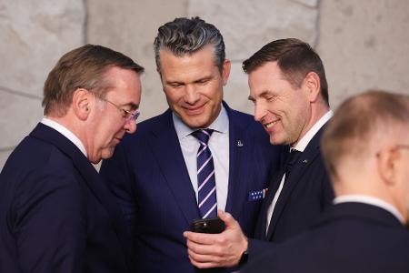Blick aufs Smartphone: Pistorius, Hegseth und Pevkur aufs Handy fokussiert