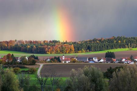 Hinter dem Dorf Dietelhofen hat sich am Morgen ein Regenbogen gebildet.