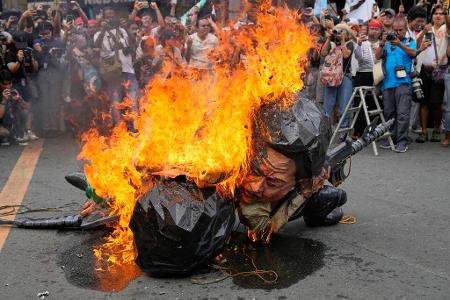 Manila: Demonstranten verbrennen Marcos-Figur am Internationalen Tag der Menschenrechte.