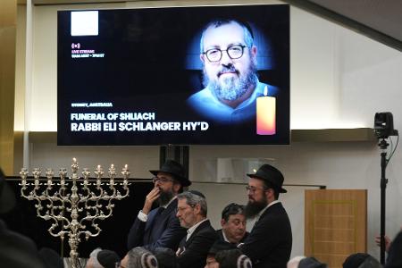 Trauernde versammeln sich in Sydney in einer Synagoge zur Beerdigung von Rabbi Eli Schlanger.