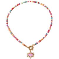 BUNGSA Goldkette Perlenkette Choker pastell/goldfarben + pinkes Evil Eye Messing Damen (1-tlg), Halskette Necklace von BUNGSA
